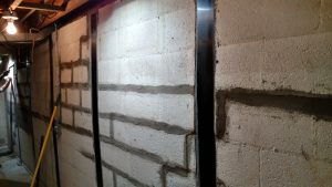 Carbon fiber foundation wall reinforcement installed on a basement block wall in Southwest Virginia